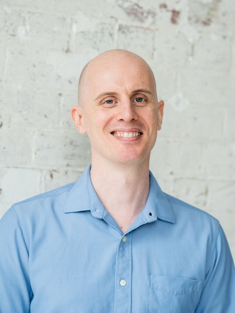 jabe brown functional medicine practitioner wearing blue shirt standing smiling